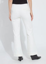Load image into Gallery viewer, Model wearing white pants and black boots against a white background.
