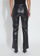 Load image into Gallery viewer, Model wearing a black wicker textured faux leather pant, black boots and black top against a white background.
