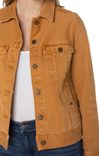 Load image into Gallery viewer, Our classic jean jacket with amazing stretch and recovery. Your go-to layering item that adds the perfect touch to any outfit made with comfortable fabric that won’t stretch out!   Color- Amber Dawn; rich gold color. Amazing stretch and recovery. Two front functional pockets. Two seam side functional pockets. 6-button front closure.
