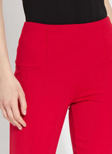 Load image into Gallery viewer, The Ankle Elysse, with its shorter 27.5-inch inseam, is an ideal fit-and-flare pant for shorter women. Crafted from 4-way stretch Ponte fabric, it gracefully contours the hips and thighs, then flares at the leg. Featuring a concealed patented waistband and front pintucks, its stunning deep red hue is sure to make a statement.
