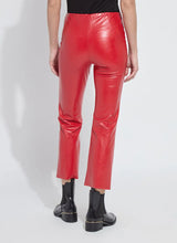 Load image into Gallery viewer, Model wearing red faux leather pants and black boots against a white background.
