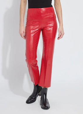Model wearing red faux leather pants and black shoes against a white background.