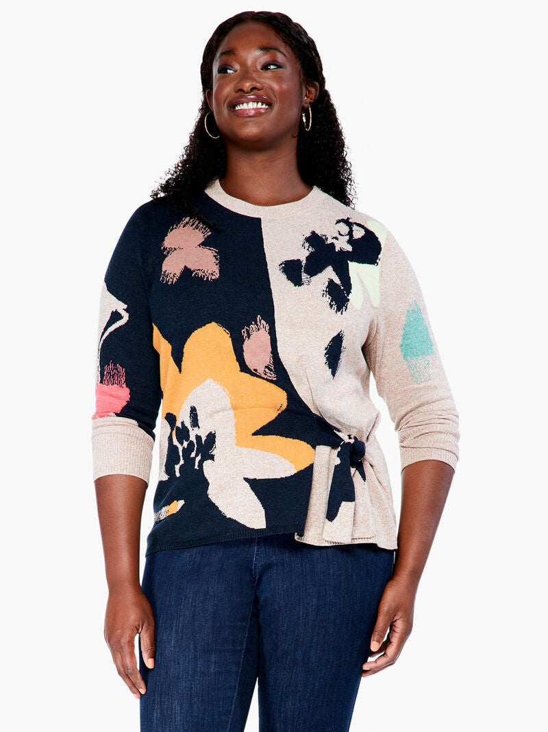 This sleek design combines patterned and natural elements to create an attractive, understated look. The intarsia pattern is seasonally versatile, while the functional side tie adds a personalized touch. Crafted with eco-friendly materials, this pullover is designed to be part of a sustainable wardrobe.  Color-Indigo multi- Navy, yellow gold, pinks, turquoise, white and sand. Pullover sweater. Intarsia knit. Midweight. Easy fit. Round neck. Tie front. Sits at hip.