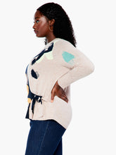 Load image into Gallery viewer, This sleek design combines patterned and natural elements to create an attractive, understated look. The intarsia pattern is seasonally versatile, while the functional side tie adds a personalized touch. Crafted with eco-friendly materials, this pullover is designed to be part of a sustainable wardrobe.  Color-Indigo multi- Navy, yellow gold, pinks, turquoise, white and sand. Pullover sweater. Intarsia knit. Midweight. Easy fit. Round neck. Tie front. Sits at hip.
