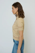 Load image into Gallery viewer, Woman wearing a short sleeve brown polo sweater with contrasting faux leather and blue jeans against a neural background.
