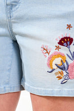 Load image into Gallery viewer, Light blue denim shorts with colorful floral embroidery on a white background.
