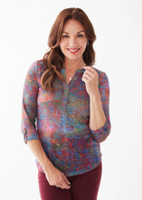 Load image into Gallery viewer, Enjoy hues of autumn shades on this beautiful French Dressing Henley top. Ideal for a crisp fall morning, wear this gorgeous top alone or layer under a favorite jacket.    Colors- Autumn Reflection- blue, orange, yellow, green, red. Henley neckline. Antique silver button hardware. Tab 3/4 sleeve. 100% Polyester
