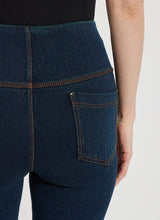 Load image into Gallery viewer, The Ankle Denim Baby Bootcut, with its 27-inch length and subtle leg flare, is the perfect pant for petite women. Crafted from 4-way stretch Knit Denim, these ankle-length bootcut pants feature a concealed patented waistband, rear patch pockets adorned with metal grommets, and anatomical seaming for a lifting and contouring effect. The jeans gracefully skim the hips and thighs, leading to a gently flared bootcut leg opening.
