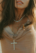 Load image into Gallery viewer, This Baby Vivi Charm Necklace is a mini version of our best-selling Vivian Cross Necklace, using pearls to create the cross hanging from our dainty 14k gold-filled chain which keeps it cute and light. The perfect soft necklace is able to stand alone and keep it simple, or stack with our other beautiful pearl styles.  Color- Gold and white. White pearls. 14K gold filled chain. 16-inch chain.
