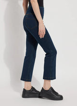 Load image into Gallery viewer, The Ankle Denim Baby Bootcut, with its 27-inch length and subtle leg flare, is the perfect pant for petite women. Crafted from 4-way stretch Knit Denim, these ankle-length bootcut pants feature a concealed patented waistband, rear patch pockets adorned with metal grommets, and anatomical seaming for a lifting and contouring effect. The jeans gracefully skim the hips and thighs, leading to a gently flared bootcut leg opening.
