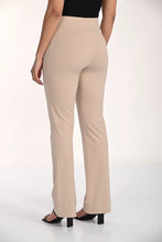 Load image into Gallery viewer, Beige pants and black sandals worn by a model on a white background.
