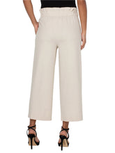 Load image into Gallery viewer, Model wearing tan wide leg crop pants with belt, black top and black heels against a white background.
