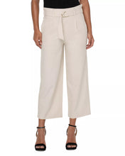 Load image into Gallery viewer, Model wearing tan wide leg crop pants with belt, black top and black heels against a white background.

