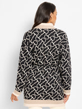 Load image into Gallery viewer, Woman wearing a black and white patterned jacket against a white background.
