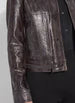 Load image into Gallery viewer, This fitted true-to-size moto jacket, crafted from 4-way stretch Patent Foil Vegan Leather, features an engineered Liquid Mocha Snake pattern, patch pockets, and chunky gunmetal zippers. This exceptionally beautiful jacket boasts a striking appearance that is certain to garner compliments.
