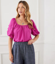 Load image into Gallery viewer, Boasting pleated tiers on the sleeves and shirring at the neck, this peasant top in a vibrant berry color, offers a charmingly feminine aesthetic. The puff sleeves elevate the look. A gorgeous top to dress up or wear casually with your favorite jeans. Color- Berry. Scoop neck. Shirttail hem. Puff sleeve. Fabric -100% Polyester.

