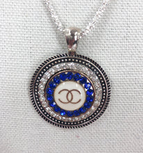 Load image into Gallery viewer, A stunning blue Coco Chanel button with gold lettering fancifully sits in a gorgeous sparkling silver base with twinkling crystals.&nbsp; This brilliant pendant hangs beautifully from a sparkling 925 silver diamond cut chain and&nbsp;is a modern take on a vintage piece. This beauty you will be proud to show off!&nbsp;
