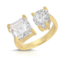 Load image into Gallery viewer, When you wear this stunning adjustable cubic zirconia ring, you will receive compliments.  The one size fits all ring has one pear shaped cz and one square cut cz with a gold base. The best of both worlds!  Color - Gold and clear. One size and adjustable. One pear shape cz and one square shape cz. 14 kt gold plate over brass.
