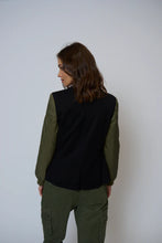 Load image into Gallery viewer, Woman wearing a black and green blazer and green pants against a white background.
