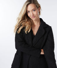 Load image into Gallery viewer, This jacket provides a unique combination of professional and casual style. The boucle texture gives it a cozier, more relaxed look. It&#39;s sophisticated yet chic, modern with a streamlined look. A timeless choice for any wardrobe.  Color -Black. Long length. Boucle. Button front closure. Front functional pockets. Fabric- 100% Polyester.
