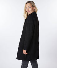 Load image into Gallery viewer, This jacket provides a unique combination of professional and casual style. The boucle texture gives it a cozier, more relaxed look. It&#39;s sophisticated yet chic, modern with a streamlined look. A timeless choice for any wardrobe.  Color -Black. Long length. Boucle. Button front closure. Front functional pockets. Fabric- 100% Polyester.
