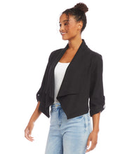Load image into Gallery viewer, Find the perfect balance between both fashion and comfort with this eco-friendly essential. Its drape collar exudes a sense of effortless sophistication, crafting a flattering silhouette to suit all body types. Color - Black. Draped collar. Roll-up sleeves with button tabs. Smocked back. Hi-low hem.
