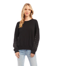 Load image into Gallery viewer, This sweatshirt is the perfect blend of comfort and sophistication. It features exquisite embellishments on each sleeve that catch the light with every movement, creating an eye-catching silhouette.  Color-Black. Long sleeves. Crew neckline. Fabric-Fleece Knit: 69% Modal. 26% Cotton. 5% Spandex. Care- Hand wash cold. Do not bleach. Hang to dry.
