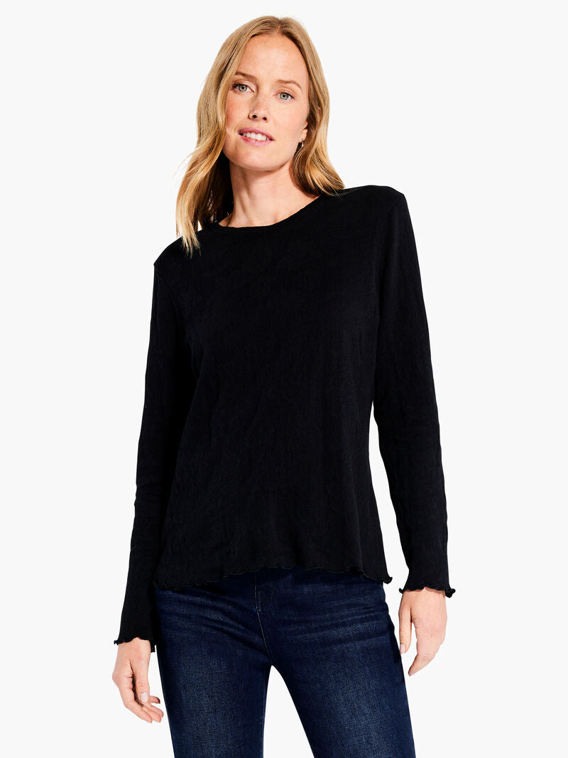 Achieve an elevated, timeless look with this black onyx knit long sleeve tee from Nic & Zoe. Crafted from a unique drapey lace knit that is comfortable and designed for all day wear, this top features a fitted crewneck silhouette, long sleeves, and a hip-length hem. Layer this top under a cardigan or jacket for an instant statement look.  Color- Black Onyx. Knit lace. Midweight. Fitted. Crewneck.