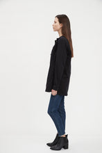 Load image into Gallery viewer, This versatile long denim jacket is ideal for transitioning between seasons. Layer up with a cozy sweater for cooler days, or pair with your favorite jeans and a tee for a more relaxed look during the warmer months. A classic and timeless style, this is a must have addition to your wardrobe.  Color - Black. Longer length. Silver button closure. Fabric -89% Cotton. 10% Polyester. 1% Spandex.
