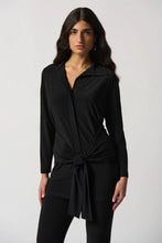 Load image into Gallery viewer, This exquisite tunic is crafted from a luxuriously silky knit fabric, complete with a shirt collar and a sash at the hips that creates a flattering fit and flare silhouette. An ideal addition to any wardrobe, this stunning piece pairs perfectly with pants or jeans.  Color- Black. Shirt collar. Sash at the hips. Button down. Unlined.
