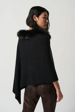 Load image into Gallery viewer, This exquisite sweater knit poncho crafted by Joseph Ribkoff is the perfect accessory for staying warm and chic during the winter months. With a luxurious faux fur crewneck and three-quarter sleeves, this poncho provides plenty of room to move while keeping you cozy and sophisticated.  Color - Black. Faux fur trim. Three quarter sleeves. Poncho design.
