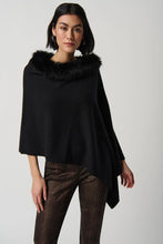 Load image into Gallery viewer, This exquisite sweater knit poncho crafted by Joseph Ribkoff is the perfect accessory for staying warm and chic during the winter months. With a luxurious faux fur crewneck and three-quarter sleeves, this poncho provides plenty of room to move while keeping you cozy and sophisticated.  Color - Black. Faux fur trim. Three quarter sleeves. Poncho design.
