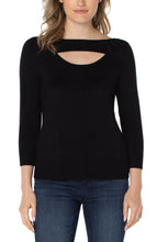 Load image into Gallery viewer, This elegant sweater features a beautiful cut out surrounded with rhinestones. Easily dress this up with one of our coatigans and vegan leather flares or dress it down with your favorite pair of denim!   Color- Black. 3/4 sleeves. Cut out detail with rhinestone details. Ribbed hem. Fabric-78% Rayon. 22% Polyester.
