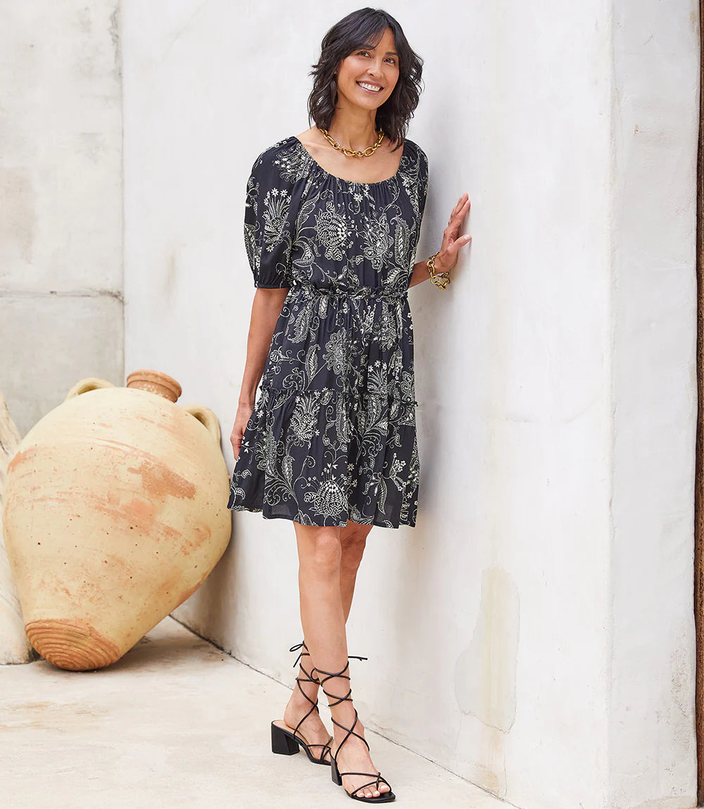 A charming scarf print puts a bohemian focus on this summer-ready dress. This statement-making dress features peasant sleeves, a tiered hem and flattering cinched waist and matching belt. Colors- Black and white. Short puff sleeve. Side pockets. Self-tie belt. Tiered hem. Cinched waist.