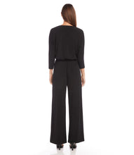 Load image into Gallery viewer, Crafted from a high-quality, wrinkle-resistant jersey fabric, this jumpsuit is as low-maintenance as it is chic. Designed for the modern jetsetter, this jumpsuit combines comfort, style, and practicality for a seamless travel experience.
