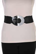 Load image into Gallery viewer, A wide black waist belt with a large, bold silver-toned metal and black oval buckle, shown worn over white top and black pants.
