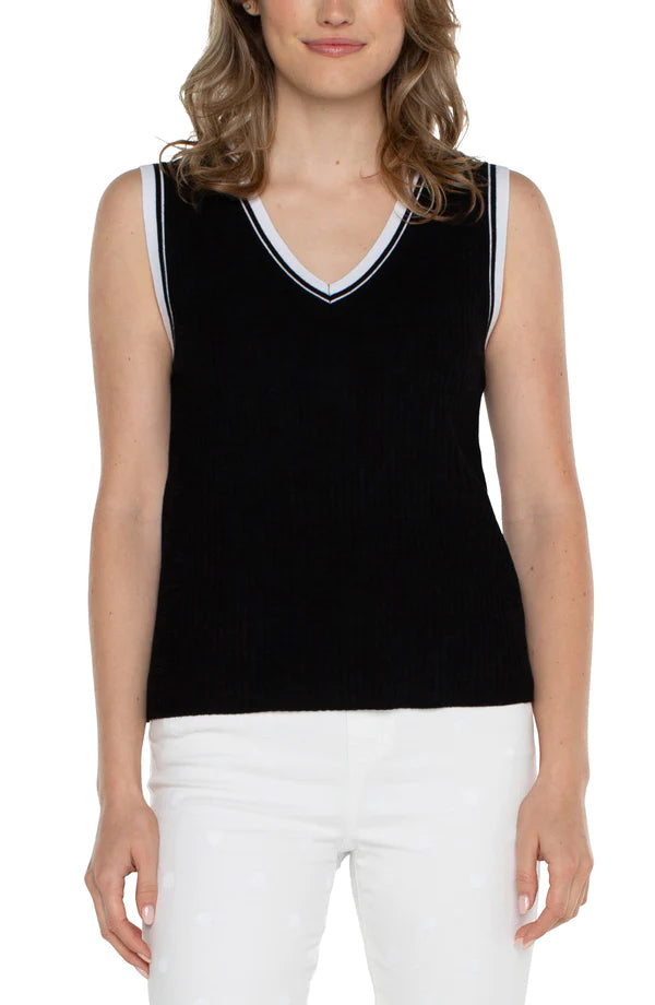 The Sherese Sleeveless V-Neck Sweater from Liverpool Los Angeles offers a luxurious black fabric with a comfortable and smooth texture. It includes a striking white ribbed accent for added style. For a trendy and coordinated look, pair it with the Oralia Open Front Contrast Trim Cardigan.  Color- Black and white. Sleeveless sweater. V-neck. Contrasting rib trim. 12 Gauge Rib.