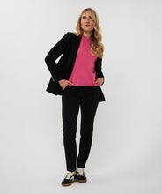 Load image into Gallery viewer, Woman wearing a black blazer with gold buttons over a pink shirt, black pants and black sneakers against a white background.

