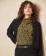 Load image into Gallery viewer, Woman wearing a black blazer and yellow patterned shirt against a beige background.
