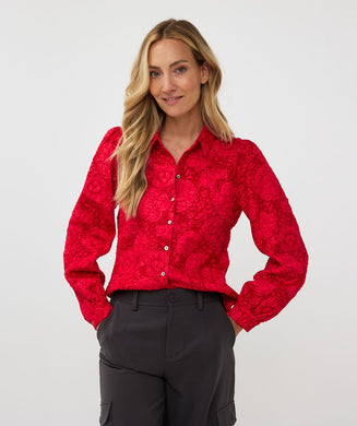 Featuring a raised floral pattern and a bold red hue, the Brandee Blouse 2tone Flower Jacquard by EsQualo is a must-have for those looking to make a statement. The thicker fabric is perfect for colder days, and can easily be dressed up with a skirt, trousers, or even your favorite denim. Don't miss out on leaving a lasting impression with this chic and unforgettable blouse.