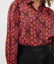 Load image into Gallery viewer, This versatile and elegant blouse, with its eye-catching abstract print in vivid colors, is an impeccable addition to any wardrobe. Made from premium fabrication, it boasts a timeless design with a contemporary flair, ensuring both comfort and fashion.
