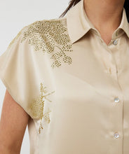 Load image into Gallery viewer, Add instant shine to your wardrobe with this radiant button-down blouse by EsQualo. Designed in a champagne hue with allover micro-sequin embellishment, the Signe Blouse features a relaxed batwing sleeve, classic shirt collar, and button-down silhouette that’s both polished and playful. Whether you’re styling it open over a tank or buttoned up with high-rise trousers, this versatile piece brings a modern twist to glamour.
