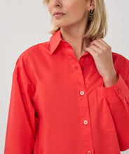 Load image into Gallery viewer, Woman wearing a red shirt on a white background.
