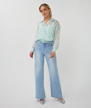 Load image into Gallery viewer, Woman wearing a light mint blouse,  jeans and silver heels on a white background.
