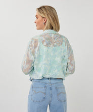 Load image into Gallery viewer, Woman wearing a light mint blouse and  jeans on a white background.
