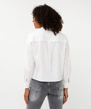 Load image into Gallery viewer, Woman wearing a white blouse and jeans against a white background.
