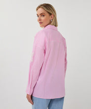 Load image into Gallery viewer, Woman wearing a pink striped shirt and blue jeans on a white background.
