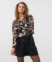 Load image into Gallery viewer, The exquisite Harmony print Blooma Blouse Mesh by EsQualo features faux pockets and gold buttons on the front, as well as a stunning abstract design in tan and black. With a double-layered construction to prevent transparency and button cuffs, this versatile top perfectly complements black pants, skirts, and jeans. Pair it with our Tanner Trousers Cargo City - EsQualo W2410709 for a chic and timeless look.
