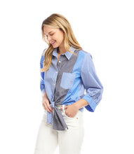 Load image into Gallery viewer, Woman wearing a blue, white and grey striped shirt standing against a white background.
