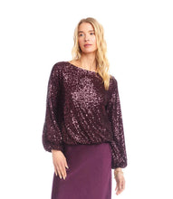 Load image into Gallery viewer, Woman wearing a purple sequin long sleeve blouse and purple silk skirt against a white background.
